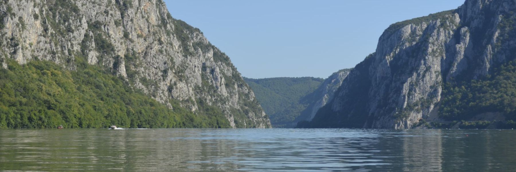 The Danube narrowing between steep forested cliffs in the Iron Gate gorge