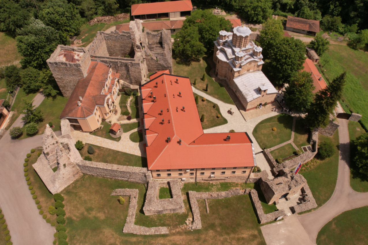 Aerial view of Ravanica monastery church, terracotta roofs and old defensive walls