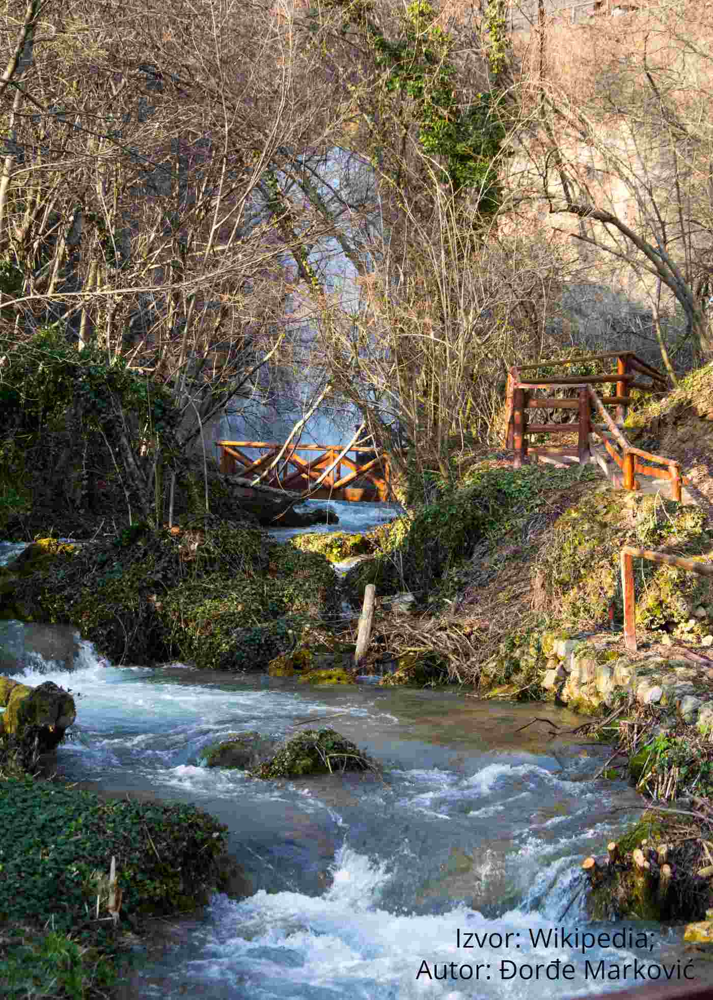 Clear stream and wooden footbridges below the Lisine waterfall